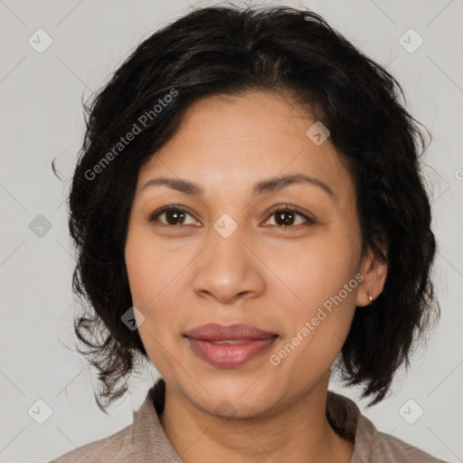 Joyful latino adult female with medium  brown hair and brown eyes