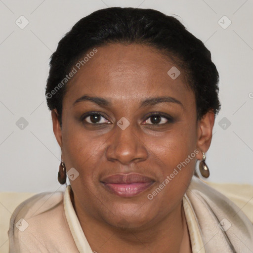 Joyful black adult female with short  brown hair and brown eyes