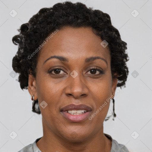 Joyful black adult female with short  brown hair and brown eyes