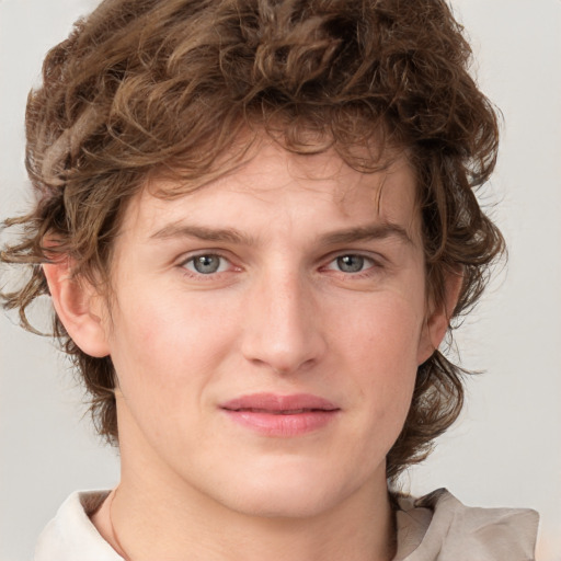 Joyful white young-adult male with medium  brown hair and grey eyes