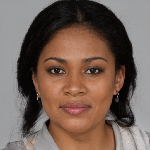 Joyful black young-adult female with medium  black hair and brown eyes