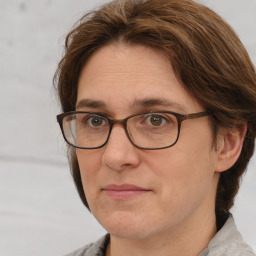 Joyful white adult female with medium  brown hair and brown eyes