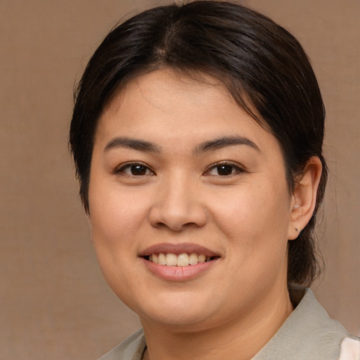 Joyful asian young-adult female with medium  brown hair and brown eyes