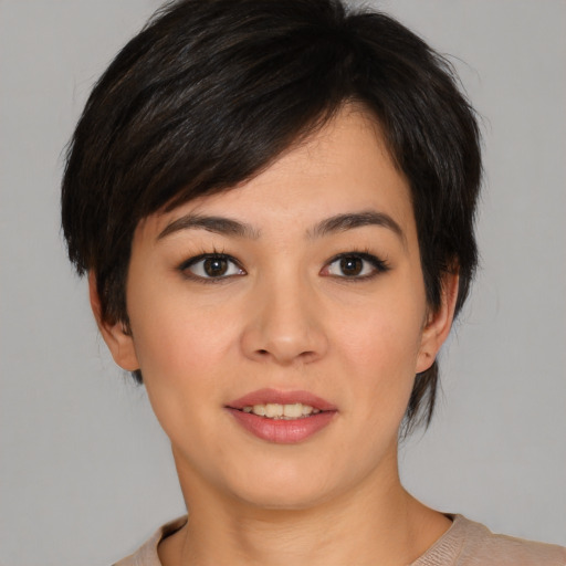 Joyful asian young-adult female with medium  black hair and brown eyes