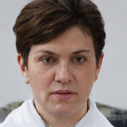 Joyful white adult female with short  brown hair and brown eyes