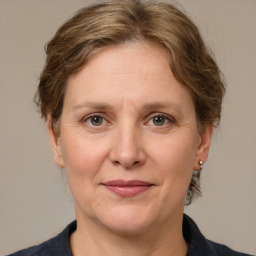 Joyful white adult female with medium  brown hair and grey eyes