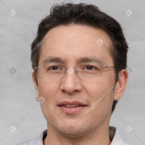 Joyful white adult male with short  brown hair and brown eyes