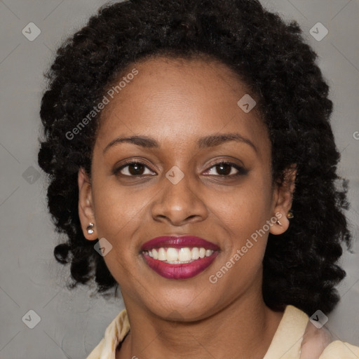 Joyful black young-adult female with long  brown hair and brown eyes