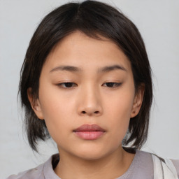 Neutral asian young-adult female with medium  brown hair and brown eyes