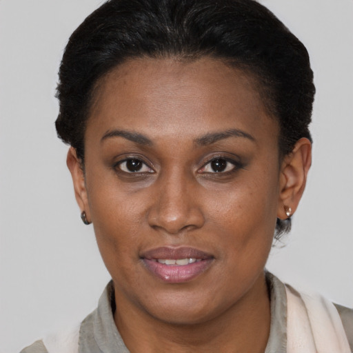 Joyful black young-adult female with short  brown hair and brown eyes