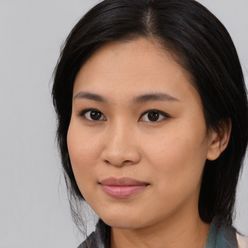 Joyful asian young-adult female with medium  brown hair and brown eyes