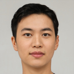 Joyful asian young-adult male with short  black hair and brown eyes