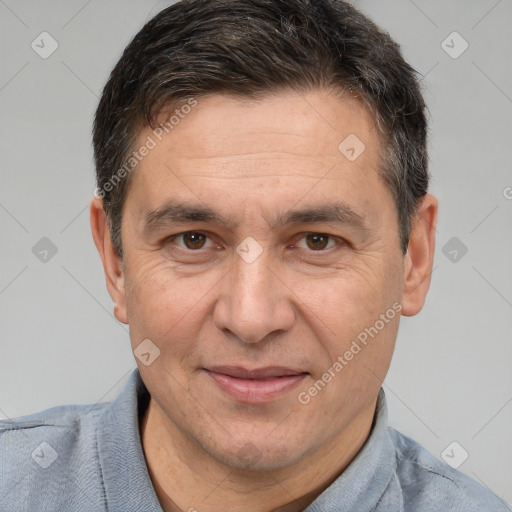 Joyful white adult male with short  brown hair and brown eyes