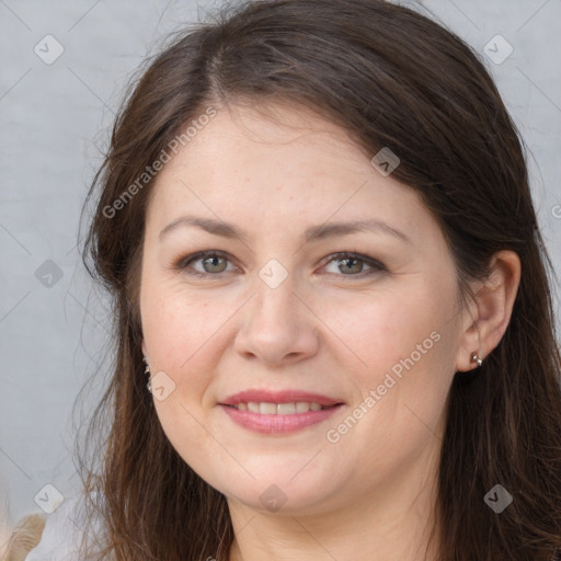 Joyful white adult female with long  brown hair and brown eyes