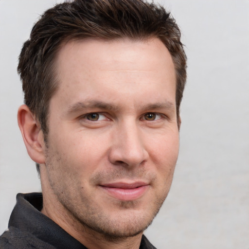 Joyful white adult male with short  brown hair and grey eyes