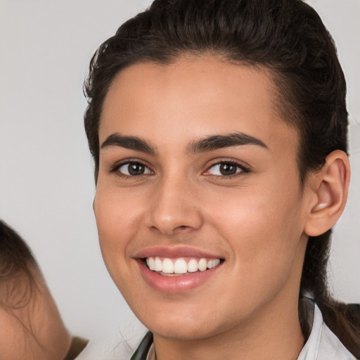 Joyful white young-adult female with medium  brown hair and brown eyes