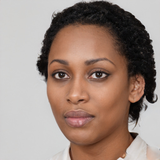 Neutral black young-adult female with short  black hair and brown eyes