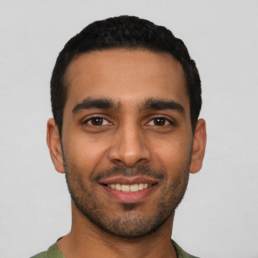 Joyful latino young-adult male with short  black hair and brown eyes