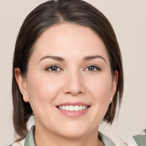 Joyful white young-adult female with medium  brown hair and brown eyes