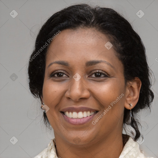 Joyful black adult female with medium  brown hair and brown eyes