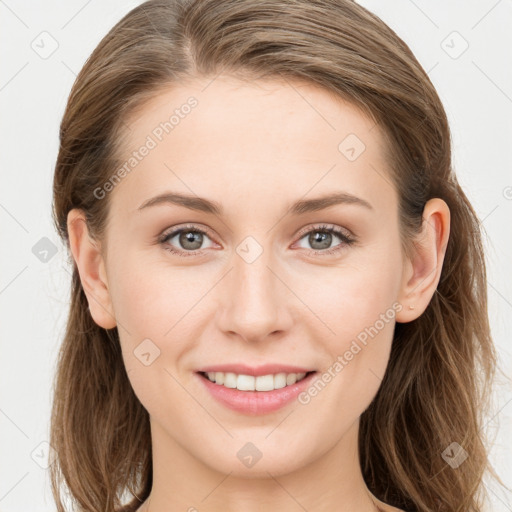 Joyful white young-adult female with long  brown hair and blue eyes