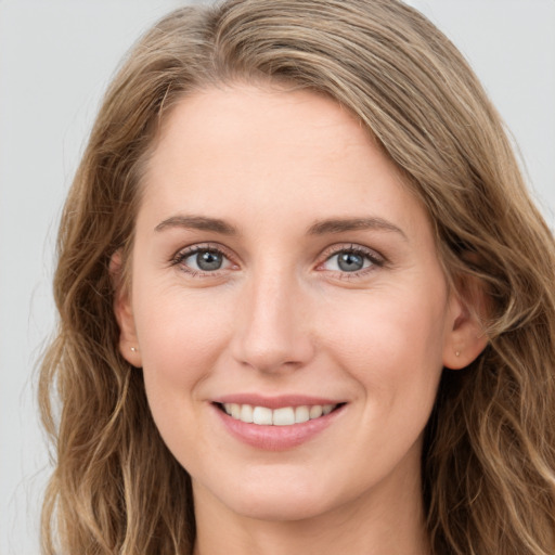 Joyful white young-adult female with long  brown hair and green eyes