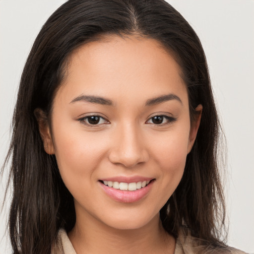 Joyful white young-adult female with long  brown hair and brown eyes