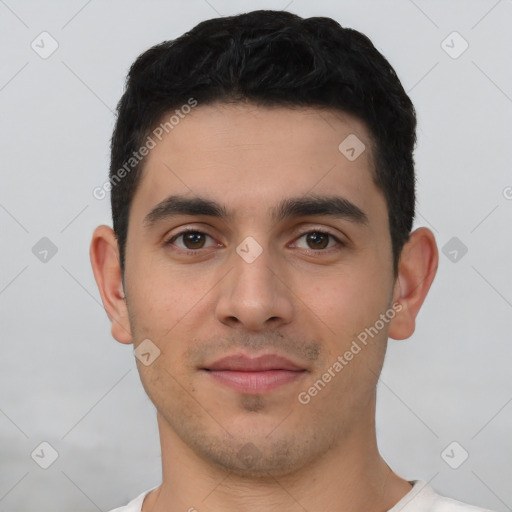 Joyful white young-adult male with short  black hair and brown eyes