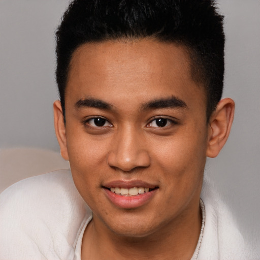 Joyful latino young-adult male with short  brown hair and brown eyes