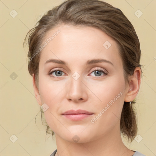 Joyful white young-adult female with medium  brown hair and blue eyes