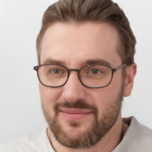 Joyful white adult male with short  brown hair and blue eyes