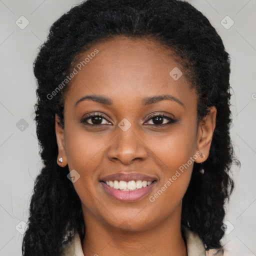 Joyful black young-adult female with long  brown hair and brown eyes