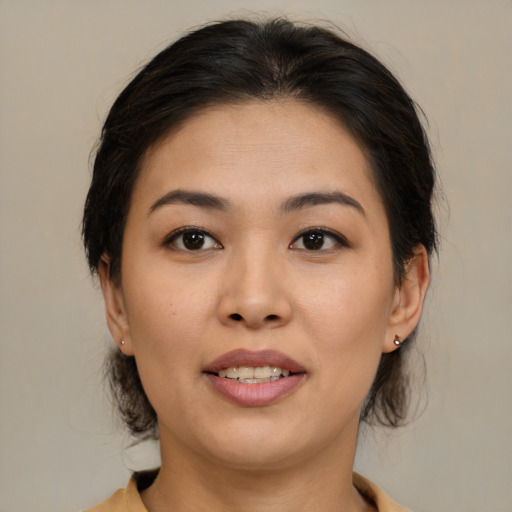 Joyful asian young-adult female with medium  brown hair and brown eyes