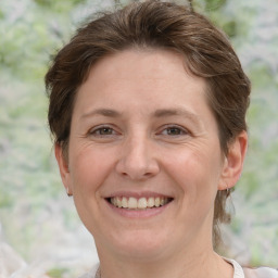 Joyful white adult female with short  brown hair and grey eyes