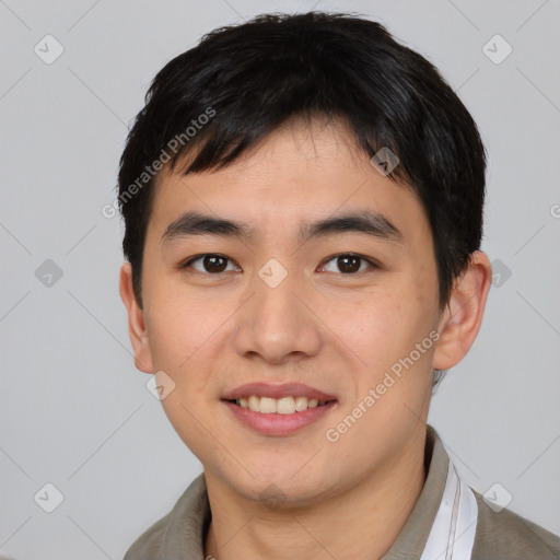 Joyful asian young-adult male with short  brown hair and brown eyes