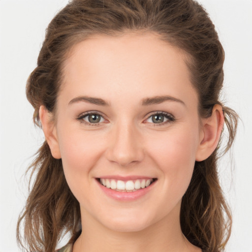 Joyful white young-adult female with long  brown hair and green eyes