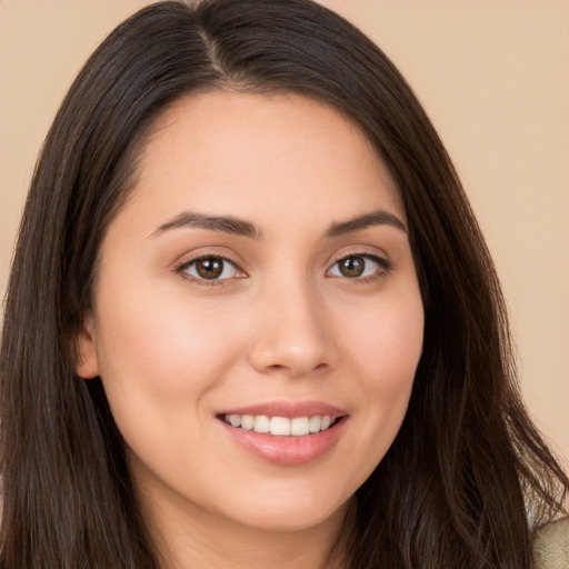 Joyful white young-adult female with long  brown hair and brown eyes