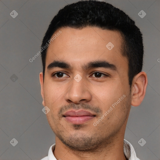 Joyful latino young-adult male with short  black hair and brown eyes