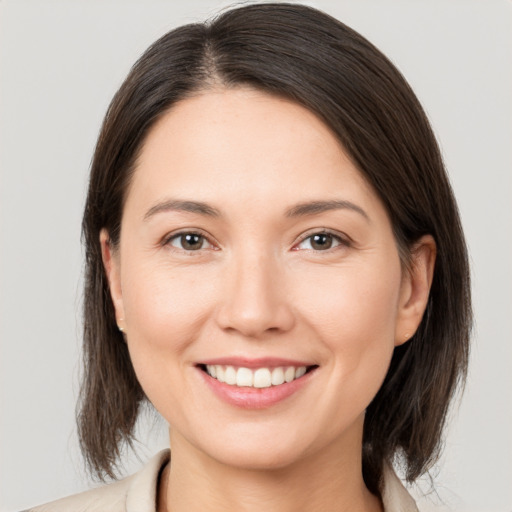 Joyful white young-adult female with medium  brown hair and brown eyes