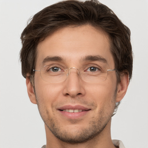 Joyful white adult male with short  brown hair and brown eyes