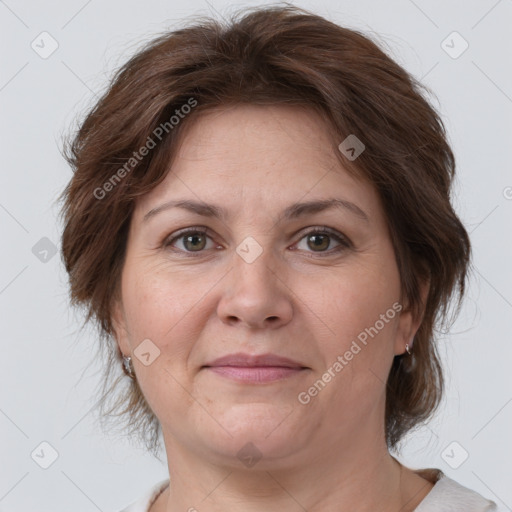 Joyful white adult female with medium  brown hair and grey eyes