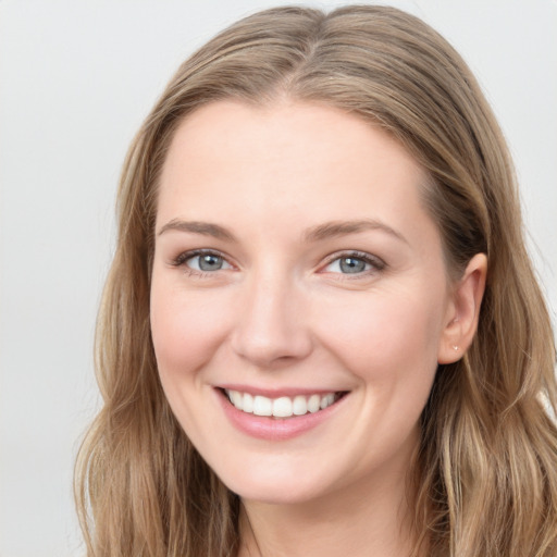 Joyful white young-adult female with long  brown hair and grey eyes