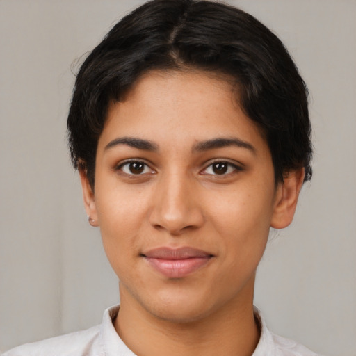 Joyful latino young-adult female with short  brown hair and brown eyes