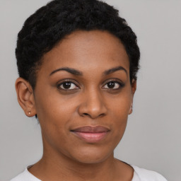 Joyful black young-adult female with short  brown hair and brown eyes