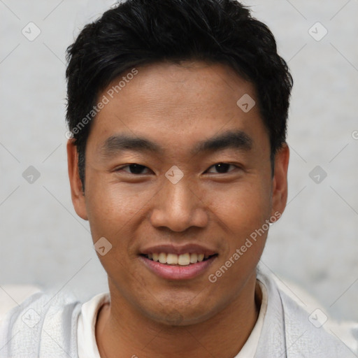 Joyful asian young-adult male with short  black hair and brown eyes