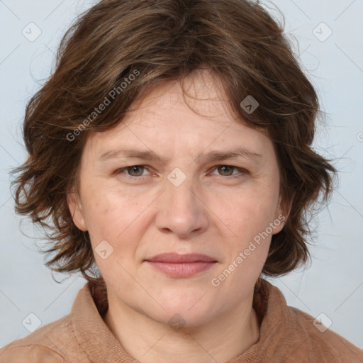 Joyful white adult female with medium  brown hair and blue eyes