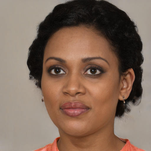 Joyful black young-adult female with medium  black hair and brown eyes