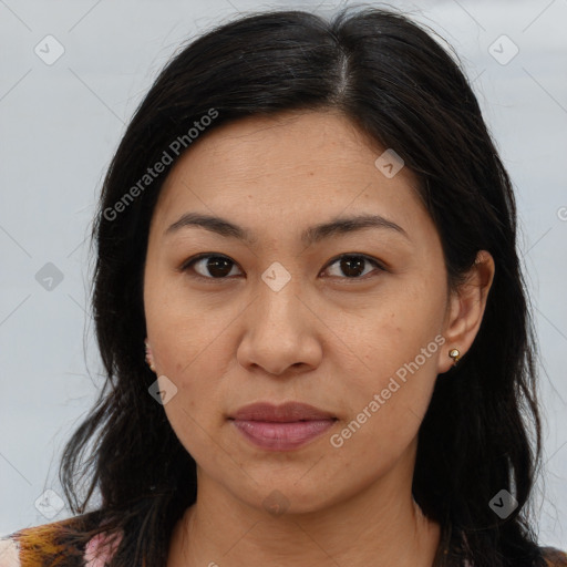 Joyful latino adult female with medium  brown hair and brown eyes