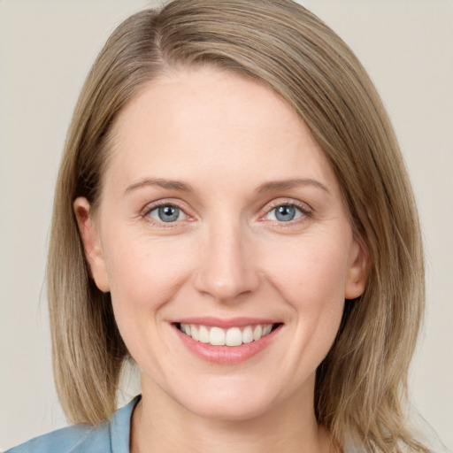 Joyful white young-adult female with medium  brown hair and blue eyes