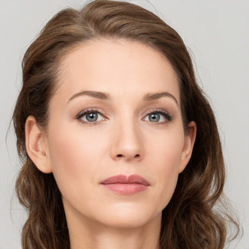 Joyful white young-adult female with long  brown hair and blue eyes